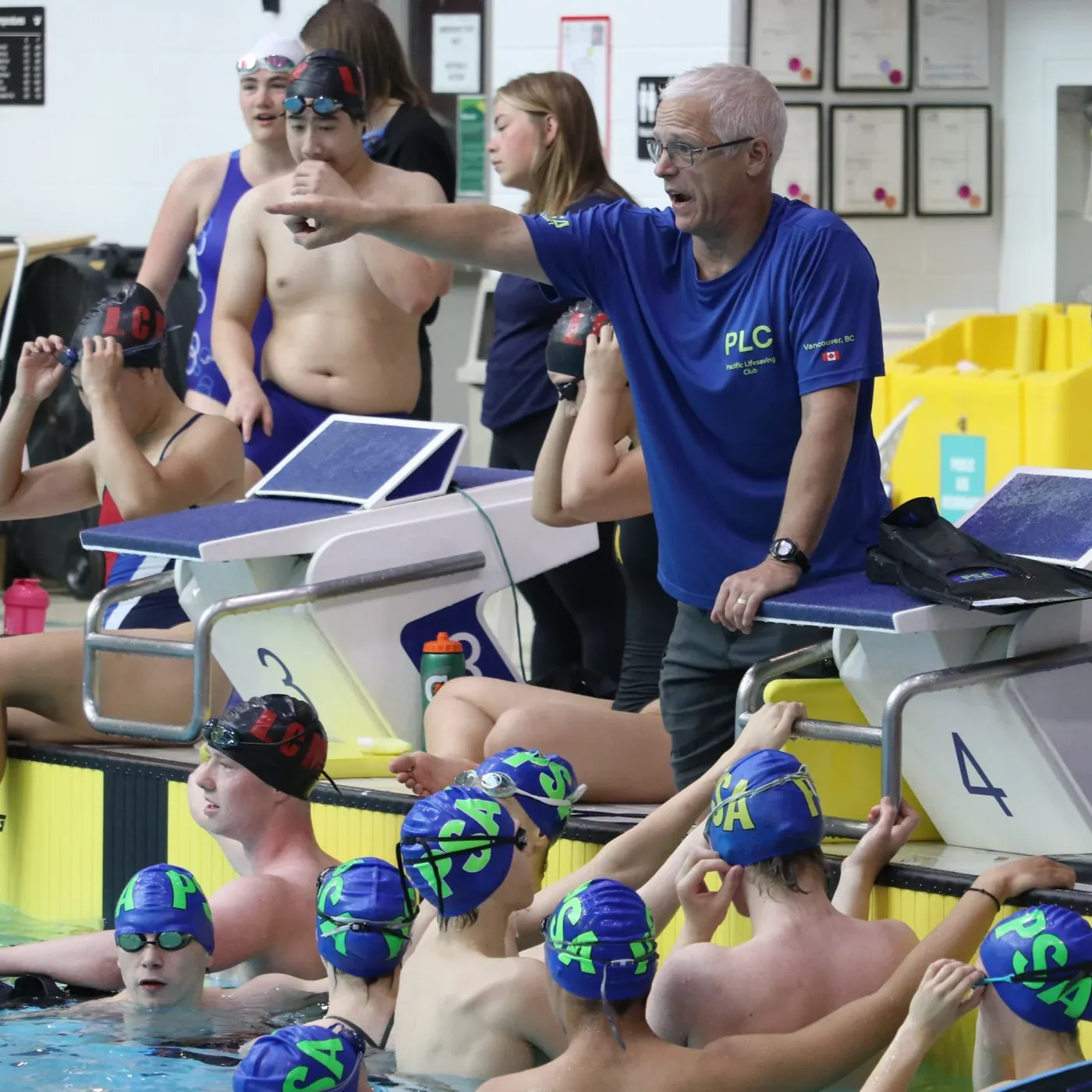 Pacific Lifesaving Club coach instructing swimmers at the pool
