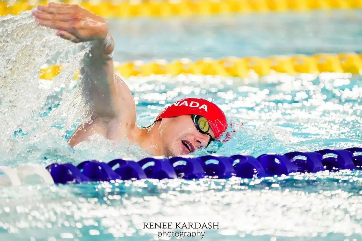 Gold-level swimmer competing in a pool race